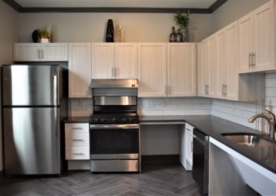 Communal kitchen with stainless steel fridge and stove in the Copper Pointe resident club