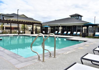 Glistening swimming pool with pergola outside resident center