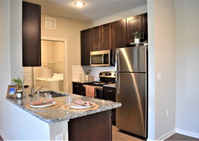 Island view of gorgeous kitchen and in-unit laundry at Copper Pointe