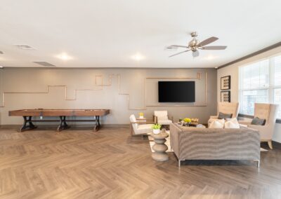Community center with a lounge area and television at Copper Pointe Apartments in San Antonio, TX
