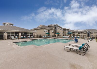 Outdoor sparkling swimming with lounge areas at Copper Pointe apartments